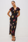 v neck long black dress with ruffled neckline and sleeves with floral blurred print model shot