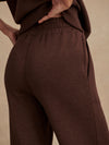 dark brown marl wide leg sweat pants with central seam down the legs and elasticated waistband with side pockets  close up of rear 