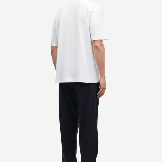 white t-shirt with crew ribbed neck, short sleeves and samsoe samsoe logo  label on side seam  rear view 