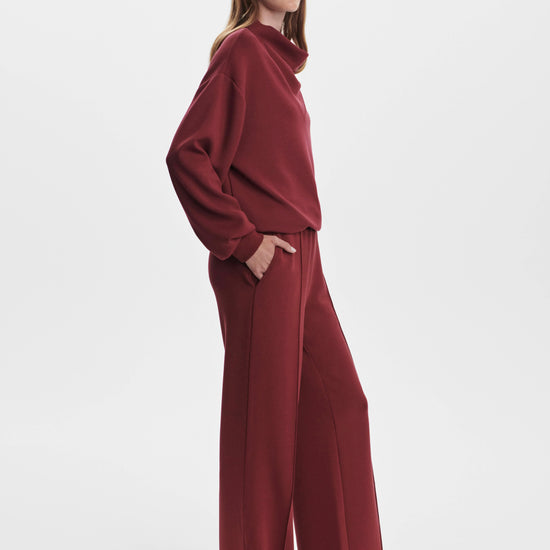 wide leg sweatpants with central front seam, elasticated waist and side pockets side view