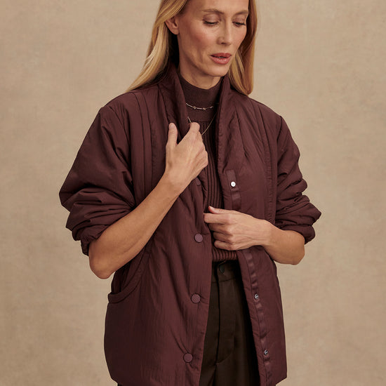 Chocolate brown padded jacket with popper buttons model shot