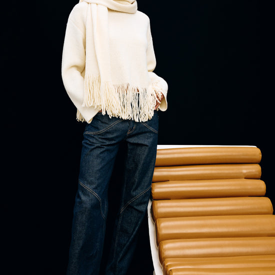 high neck ivory wool jumper with fringe along the hemline model shot