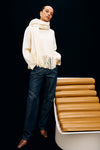 high neck ivory wool jumper with fringe along the hemline model shot