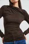 brown bodycon top with high neck, rouche detailing and long sleeves close up