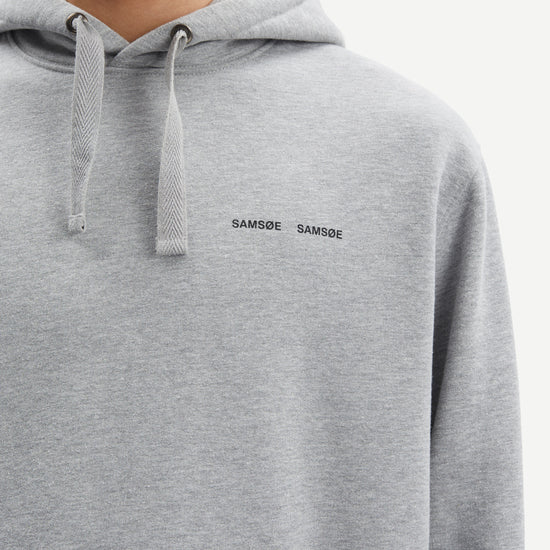 grey hoodie with samsoe samsoe chest logo, drawstring hood and kangaroo style front pocket close up