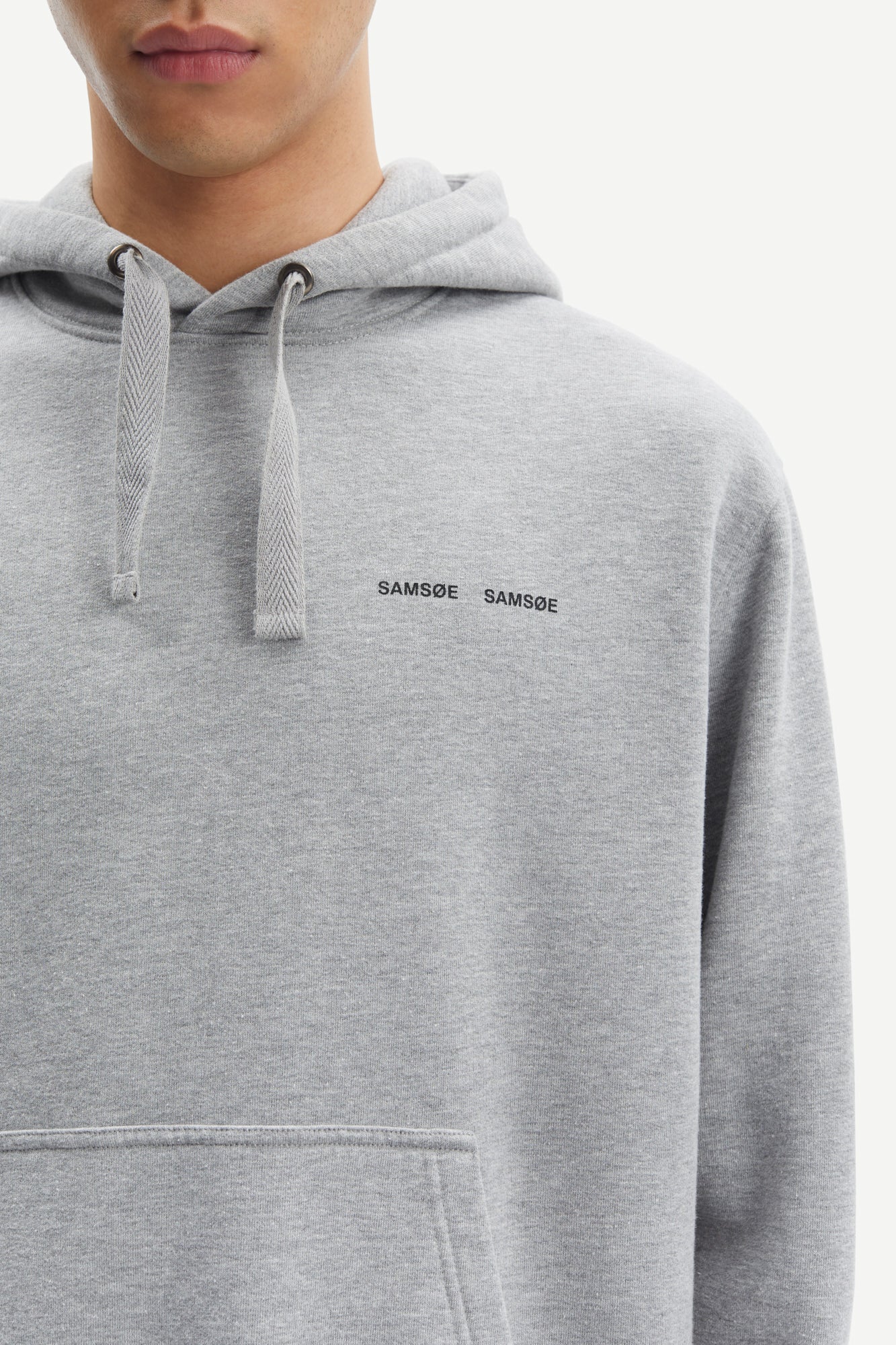 grey hoodie with samsoe samsoe chest logo, drawstring hood and kangaroo style front pocket close up