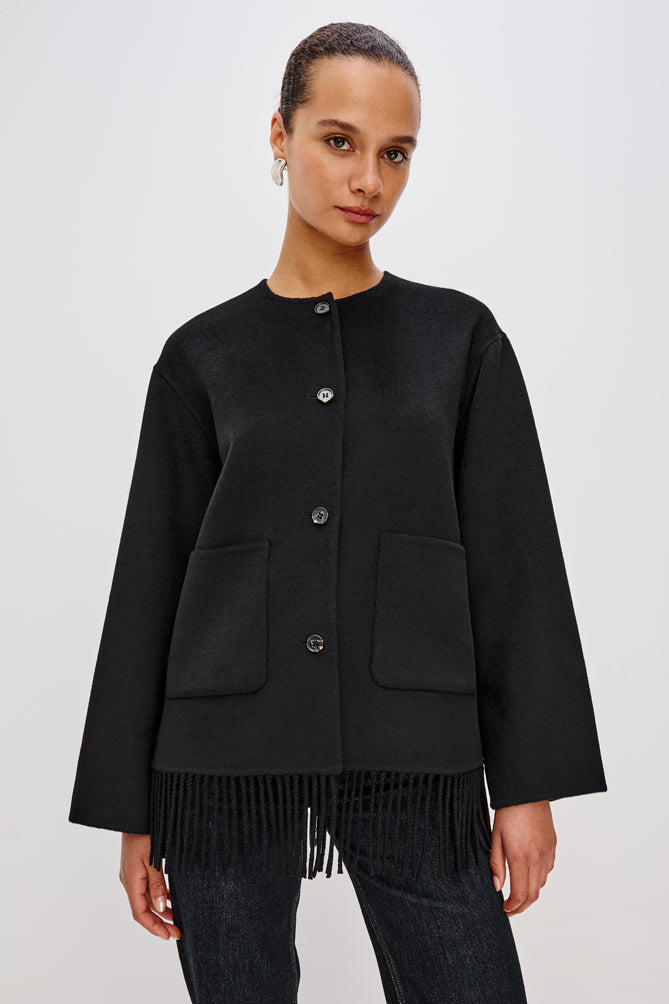 short black wool coat with patch pockets on front and fringe detailing along the hem