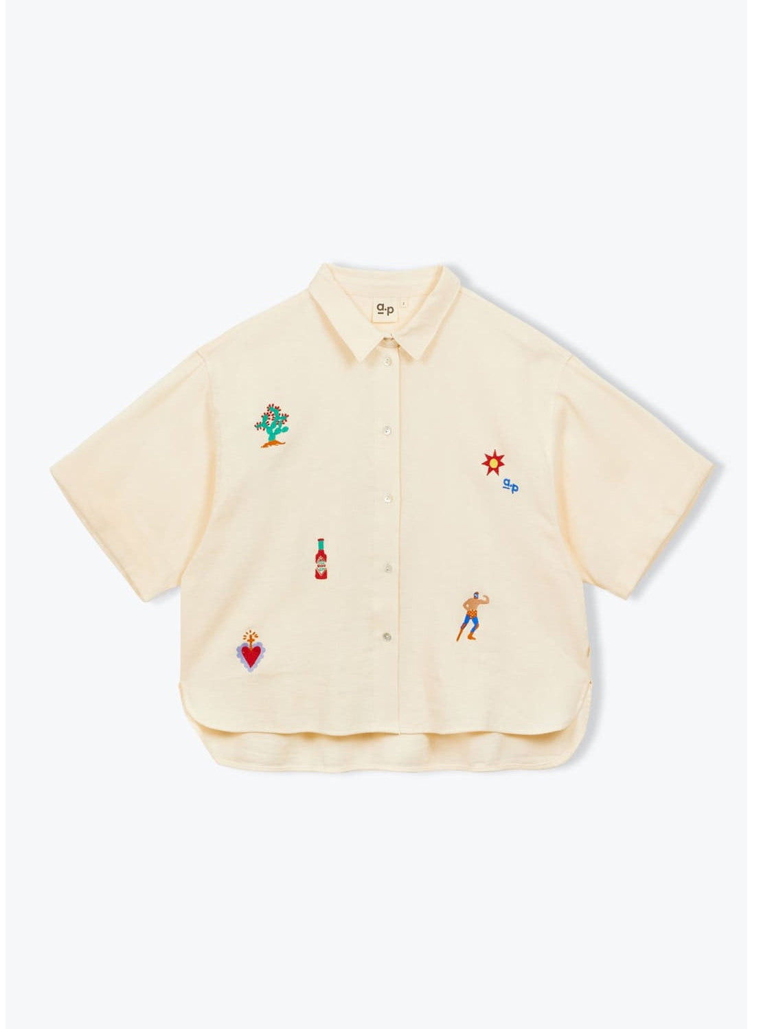Beige shirt with colorful embroidered designs on a white background