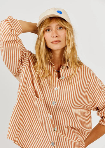 Model wearing a vertical stripe shirt on a white background 
