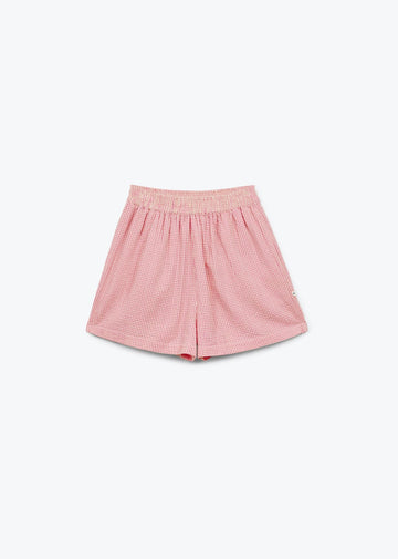 Pink checkered shorts on a white background