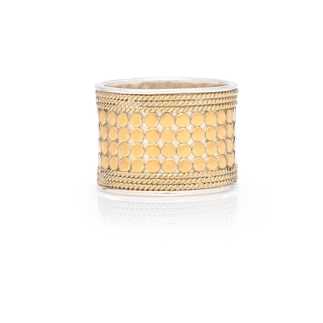Wide gold ring with silver rim and small gold dots