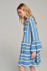 Ecru base short dress with panelled skirt and fluted bracelet length sleeves with blue geometric all over embroidery