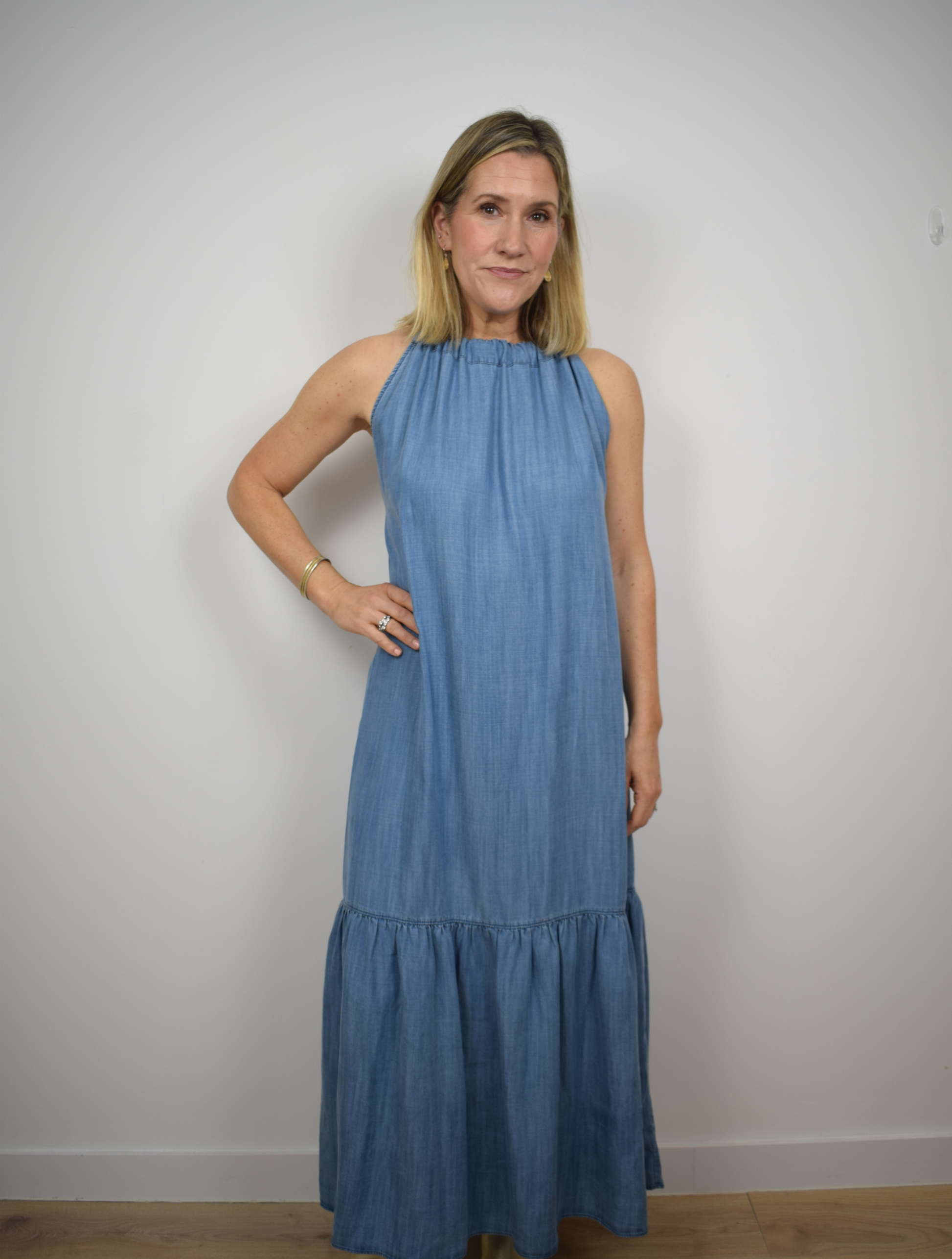 Halterneck light denim long dress with tier ruffle neck and fabric tie belt