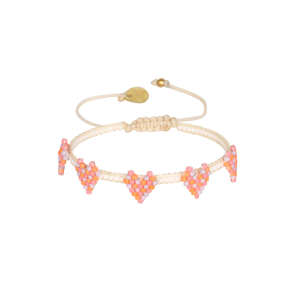 cream beaded bracelet with pink orange and lilac beaded heart details