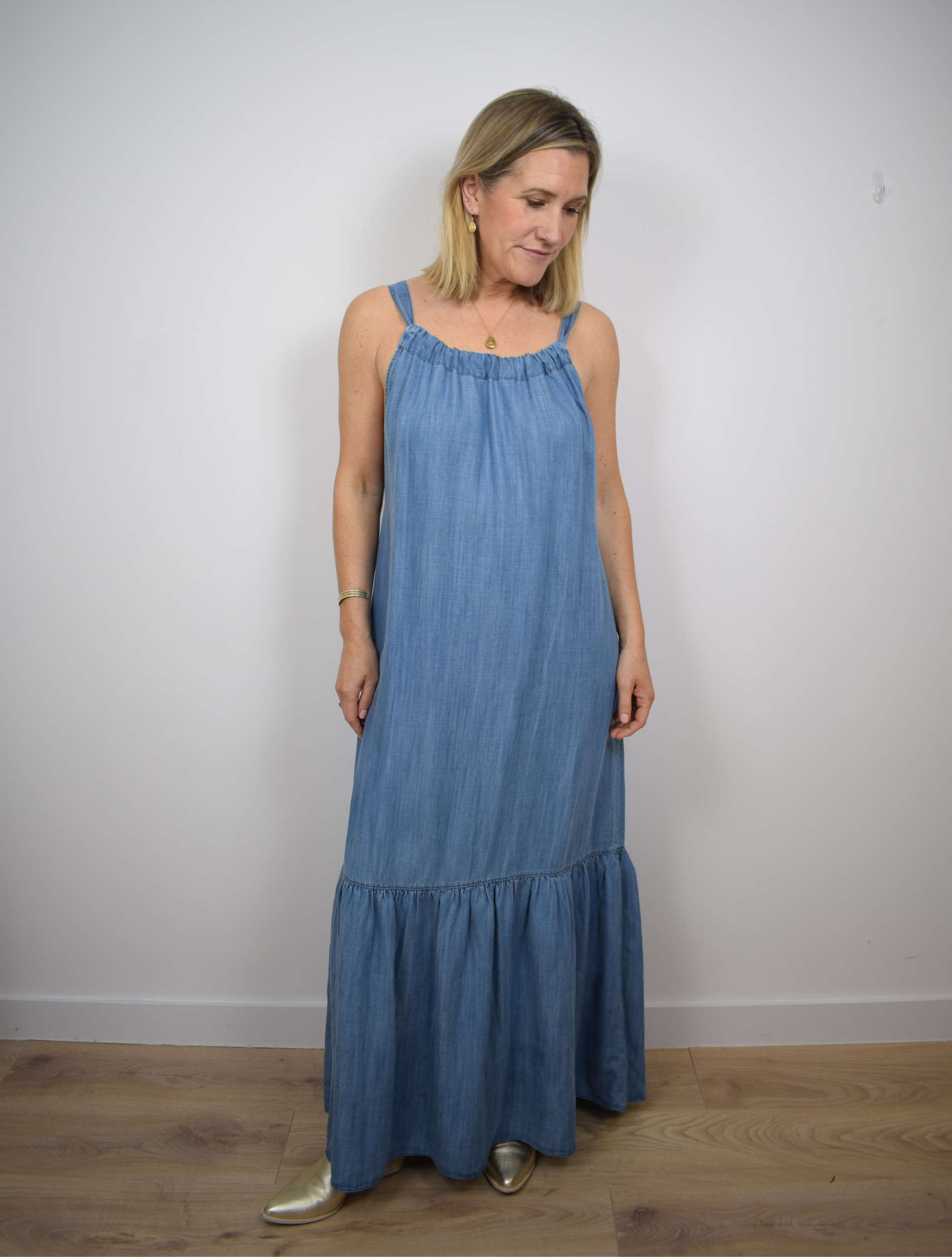 Halterneck light denim long dress with tier ruffle neck and fabric tie belt