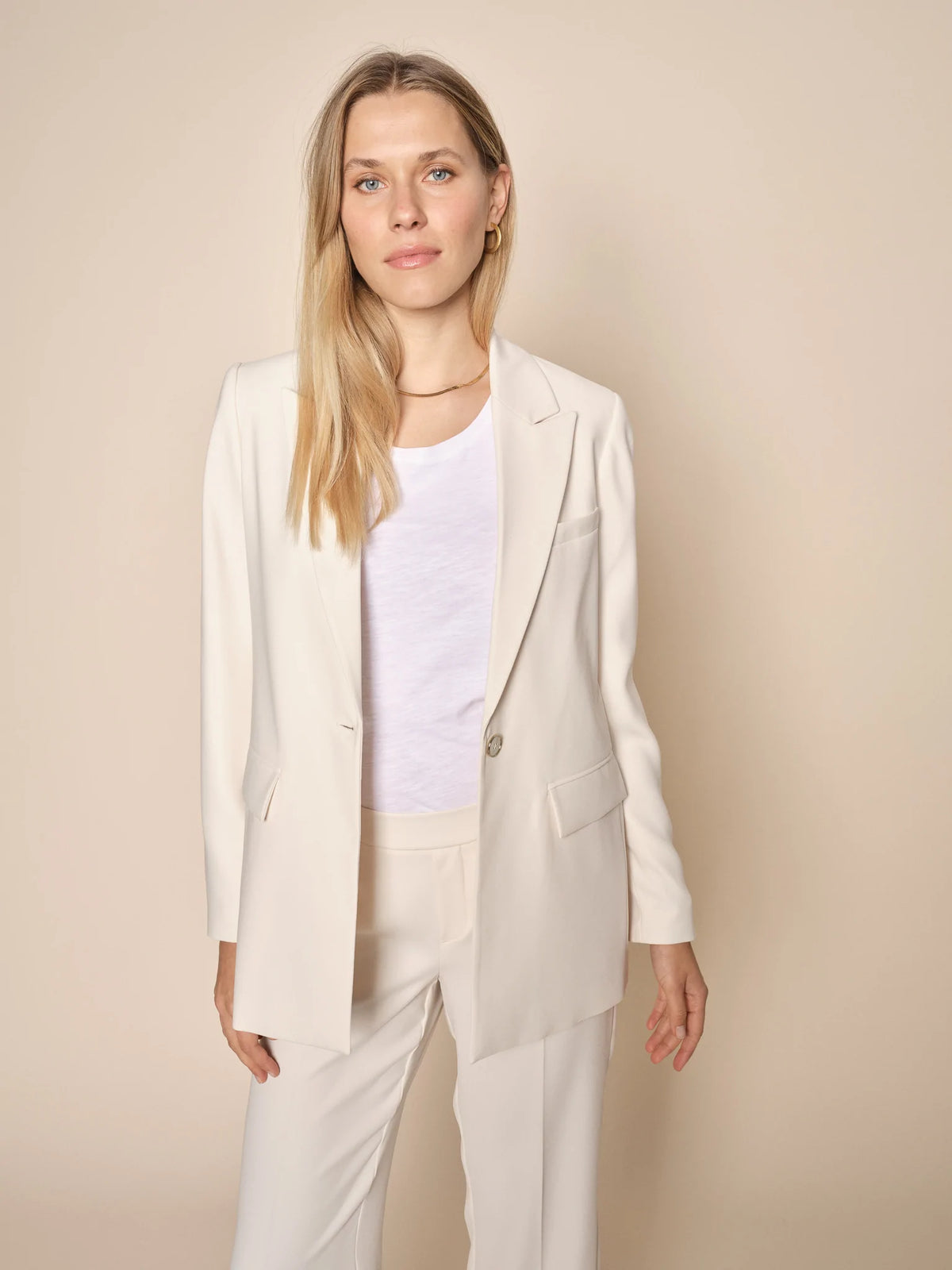 Ecru single breasted blazer with handkerchief pocket two front flap pockets and botch neck long sleeves 