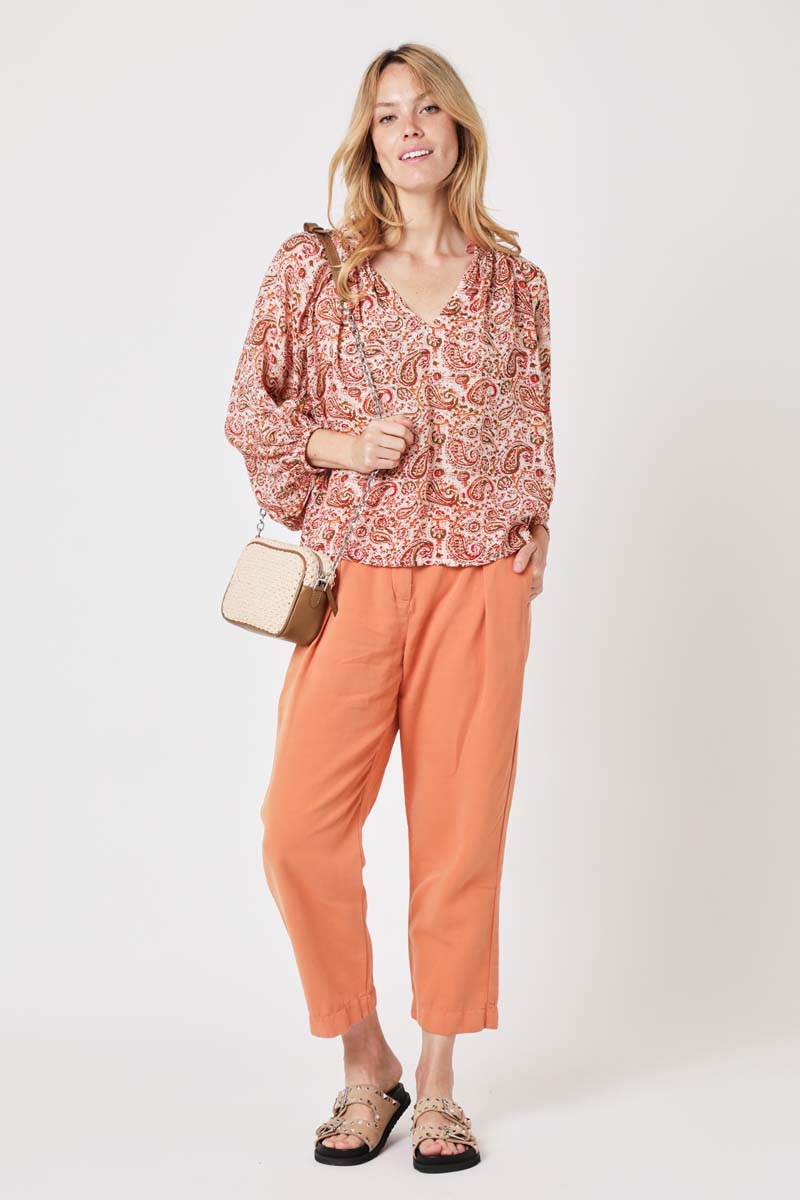 V neck long sleeved paisley top in orange red and khaki in a ecru background