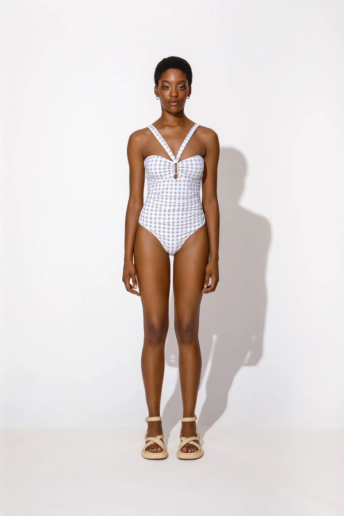 Tie neck swimsuit in blue tile print with ruched detail sides