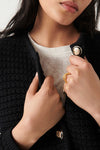 Cropped black chunky knitted cardigan with gold and enamel buttons crew neck and slightly cropped sleeves
