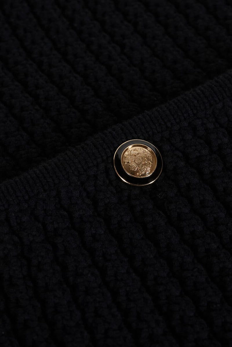 Cropped black chunky knitted cardigan with gold and enamel buttons crew neck and slightly cropped sleeves