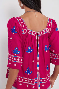 Pink top with blue and white detail 