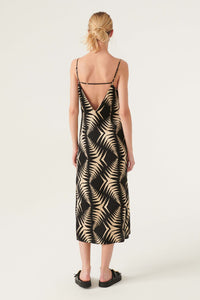 V neck satin look slip dress with geometrical pattern in black and taupe midi length with adjustable spaghetti straps with a horizontal strap at the back