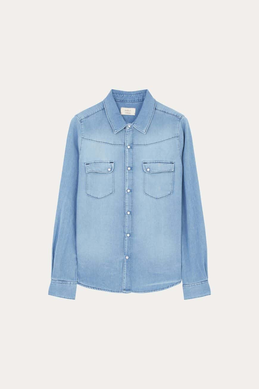Faded blue denim shirt with long sleeves classic collar and mother of pearly stud fastenings with two patch pockets at the chest