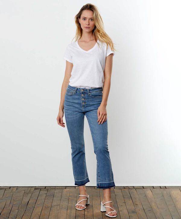 Pale wash jeans with a kick flare raw hem and exposed buttons