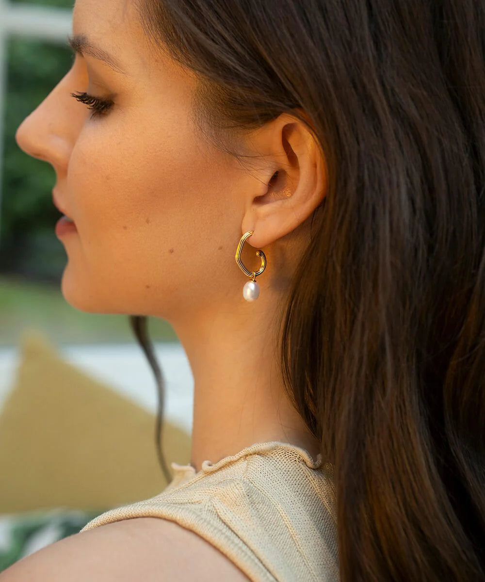 Gold plated grooved tubing hoop earrings with post and butterfly fastening and single freshwater pearl pendant