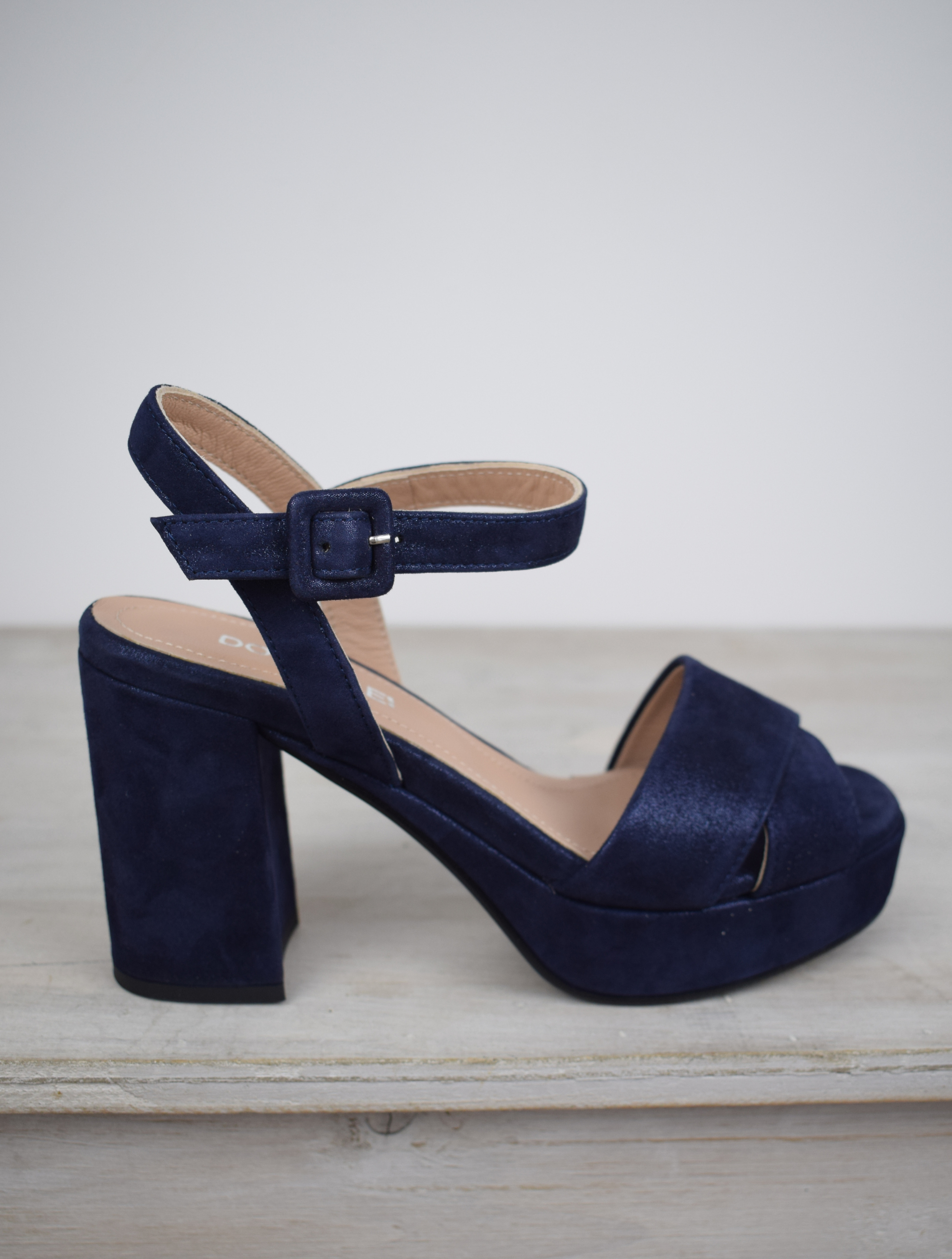 Navy sparkle platform sandal with cross straps and ankle strap with buckle fastening