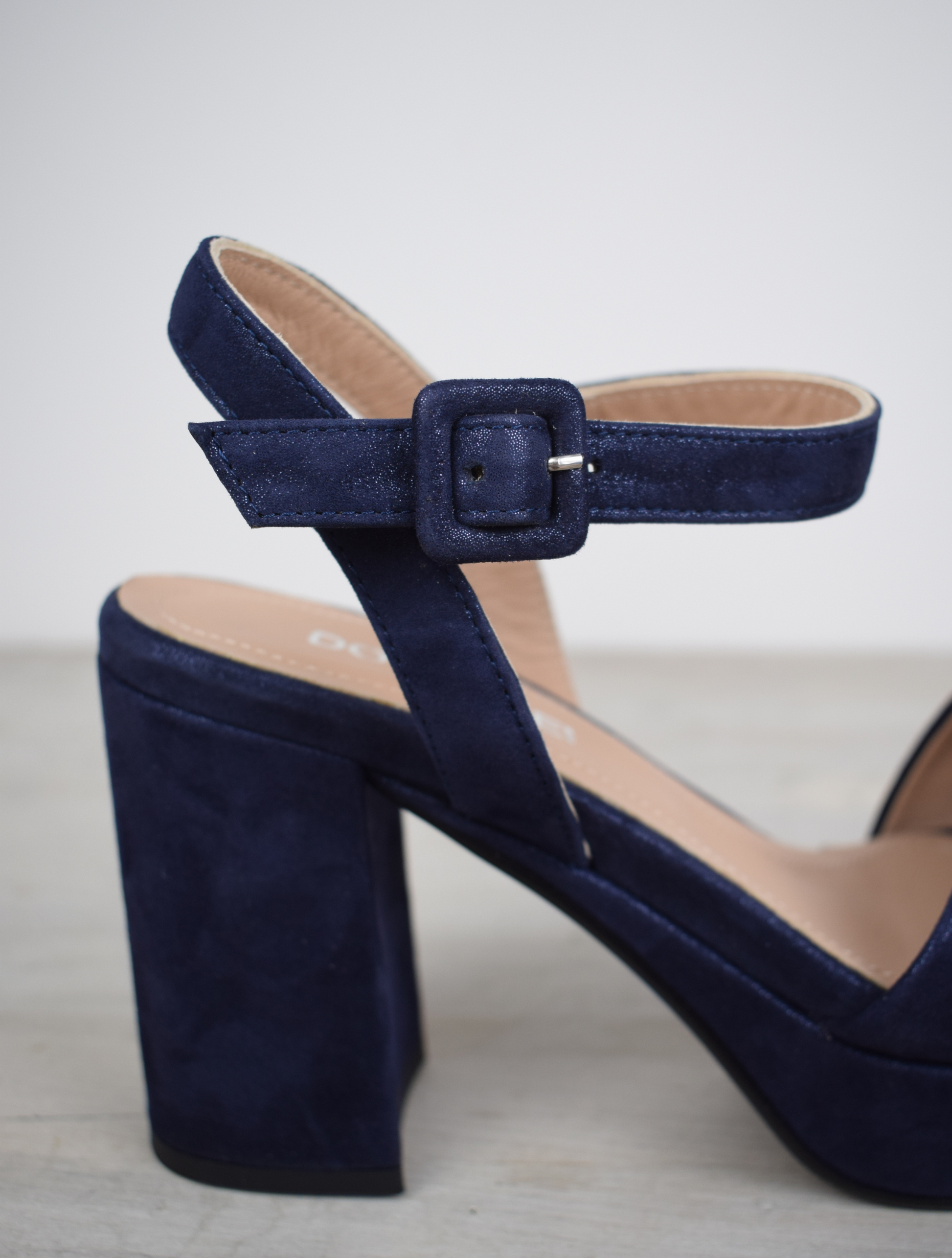 Navy sparkle platform sandal with cross straps and ankle strap with buckle fastening