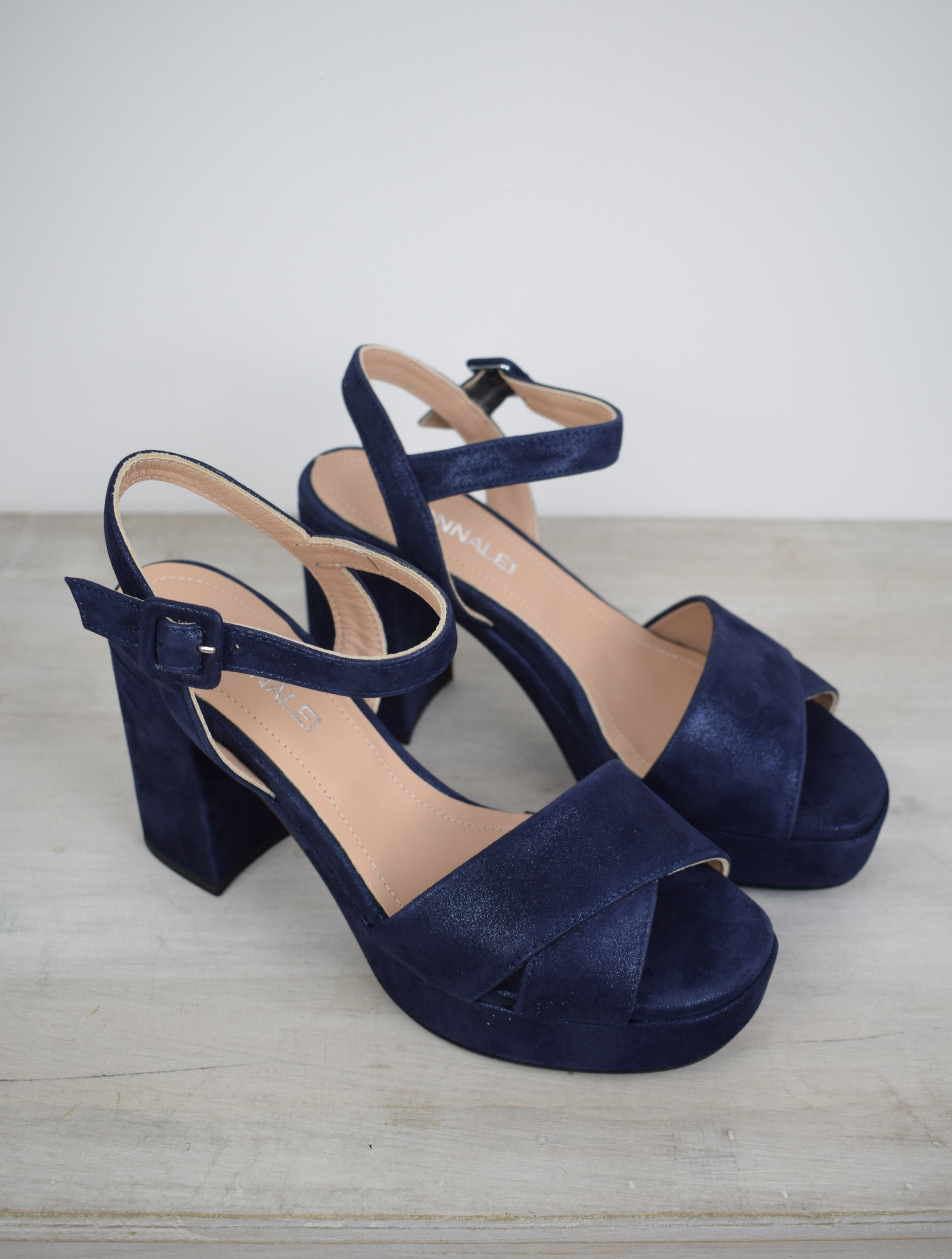 Navy sparkle platform sandal with cross straps and ankle strap with buckle fastening