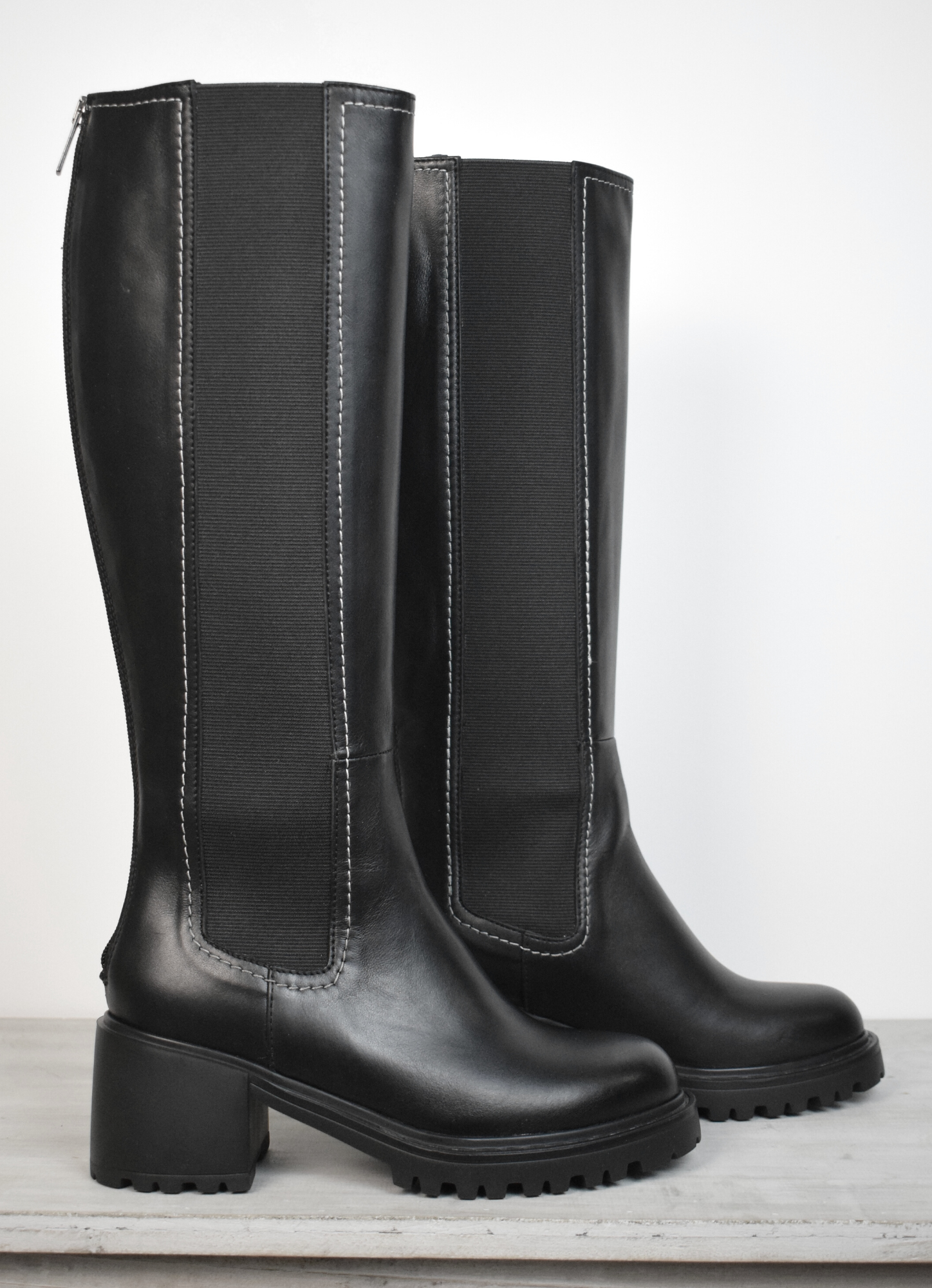 Black knee high boot with white edging and block heel 