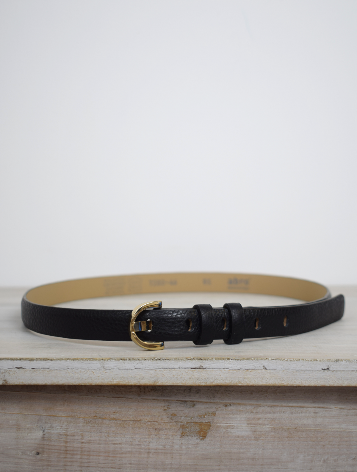 Thin black leather belt with gold D shaped buckle