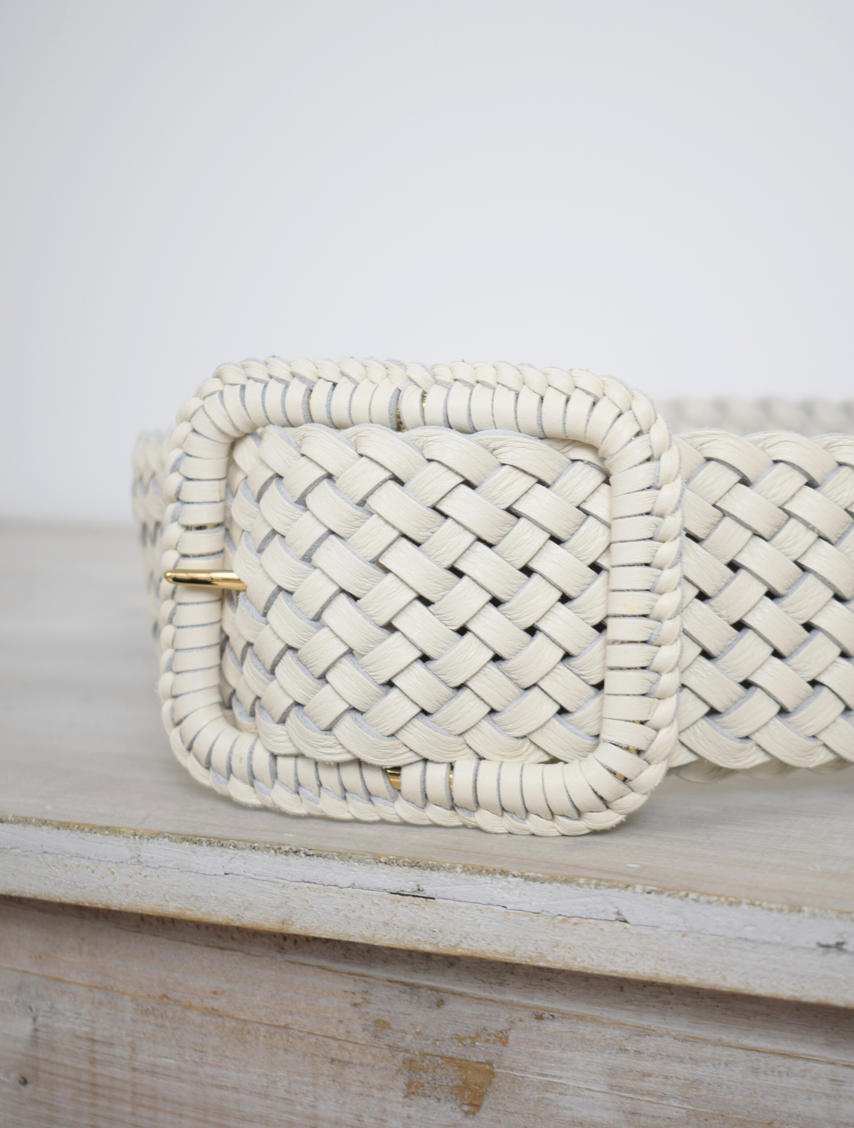 Wide plaited ivory leather belt with oblong leather bound buckle
