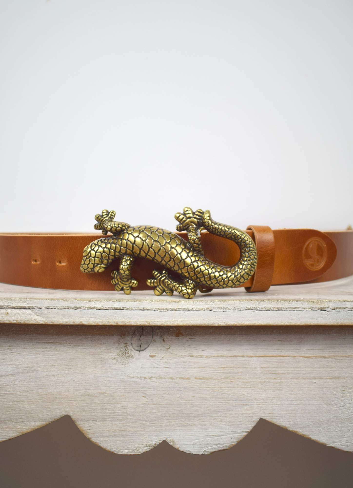 Tan leather bag strap with bronze salamander with lizard buckle