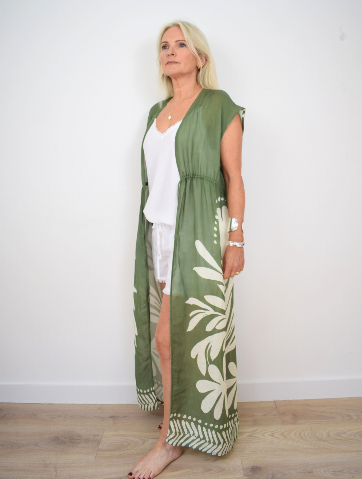 Green long kaftan with self tie drawstring waist and ecru bold floral design and border at hem