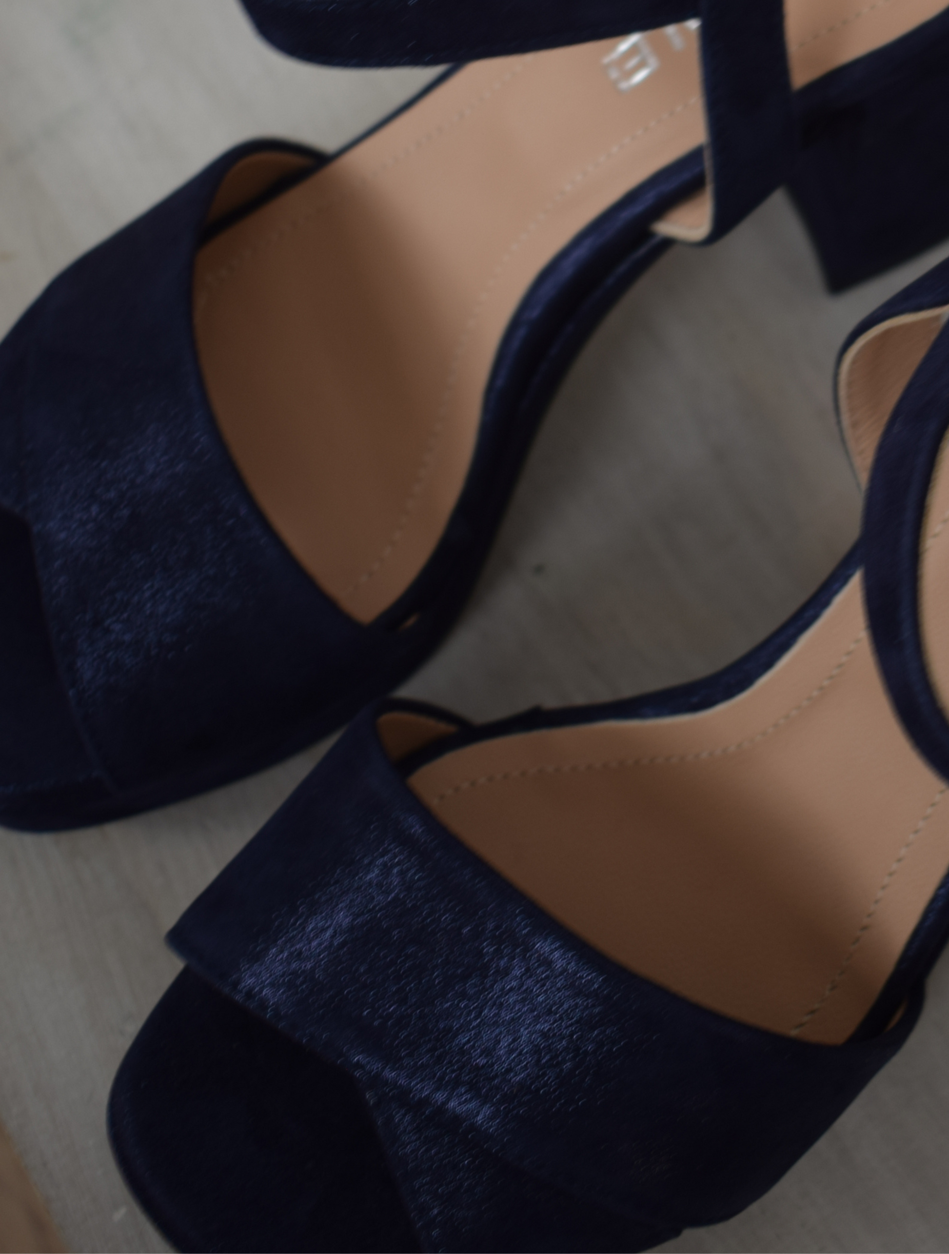 Navy sparkle platform sandal with ankle strap and leather buckleNavy sparkle platform sandal with cross straps and ankle strap with buckle fastening