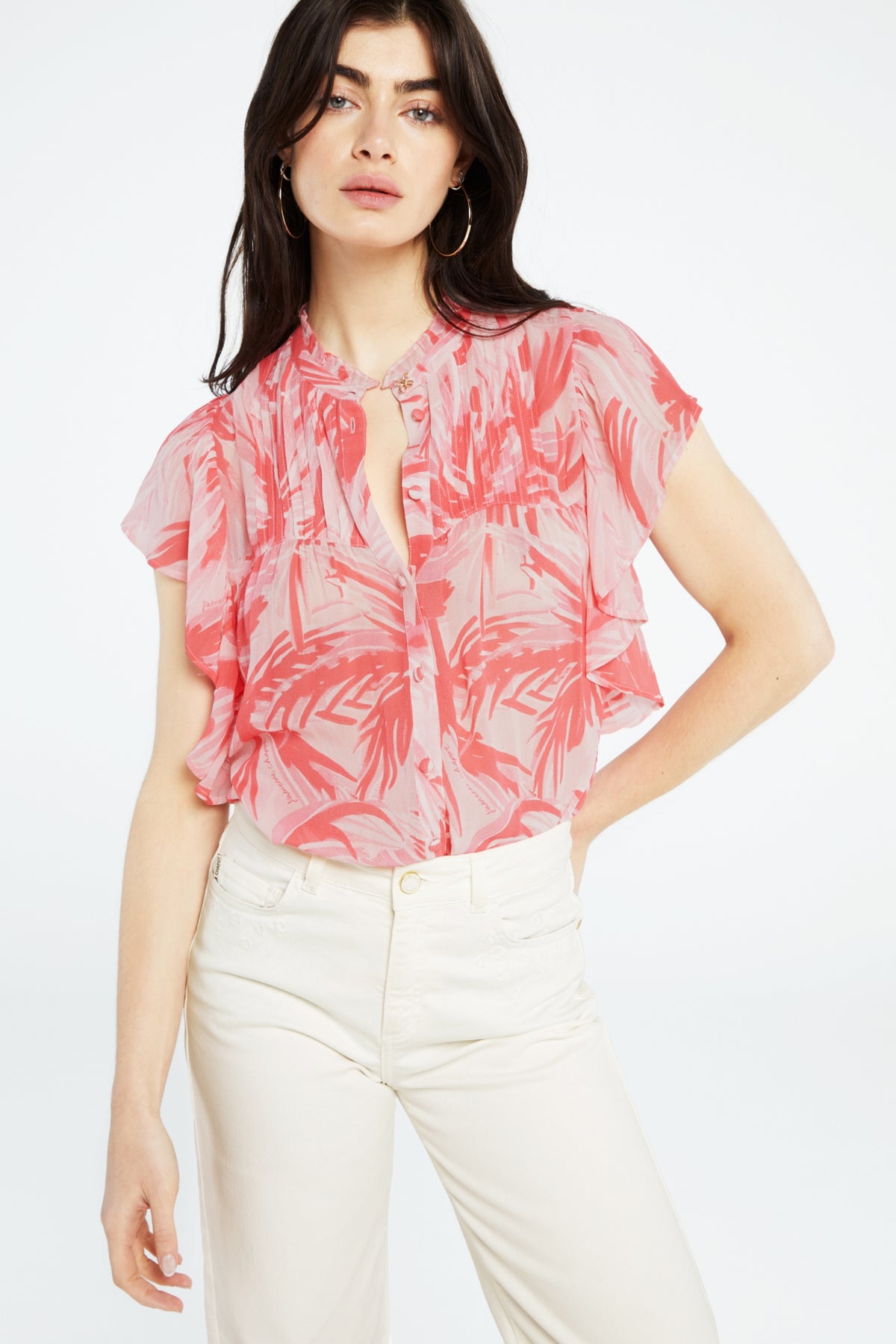 Pink tropical print blouse with full length placket covered buttons and ruffle sleeves