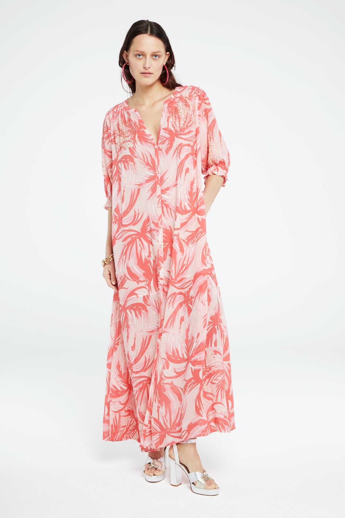 Pink blush and coral tropical floral print maxi shirt dress with elbow length sleeves with iridescent sequin bursts on the upper bodice and sleeves