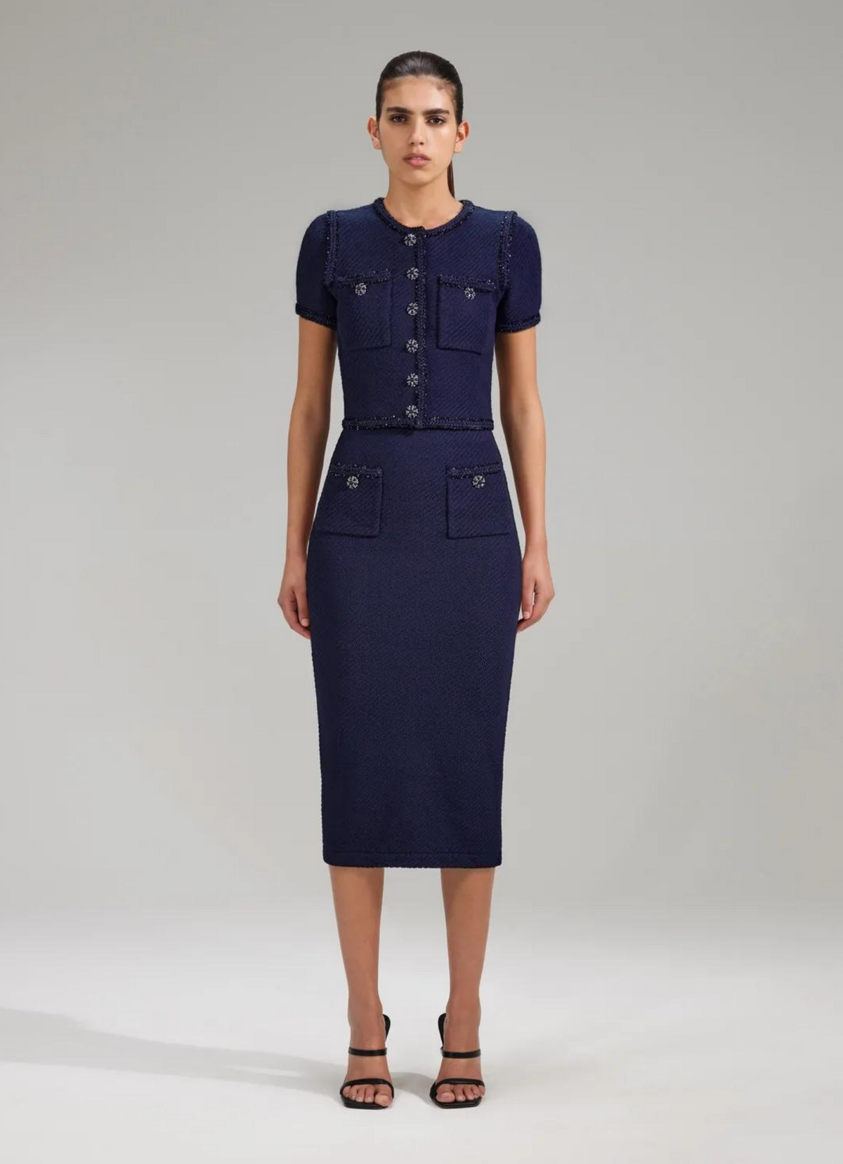Midi navy knitted pull on skirt with two patch pockets and diamanté press stud buttons
