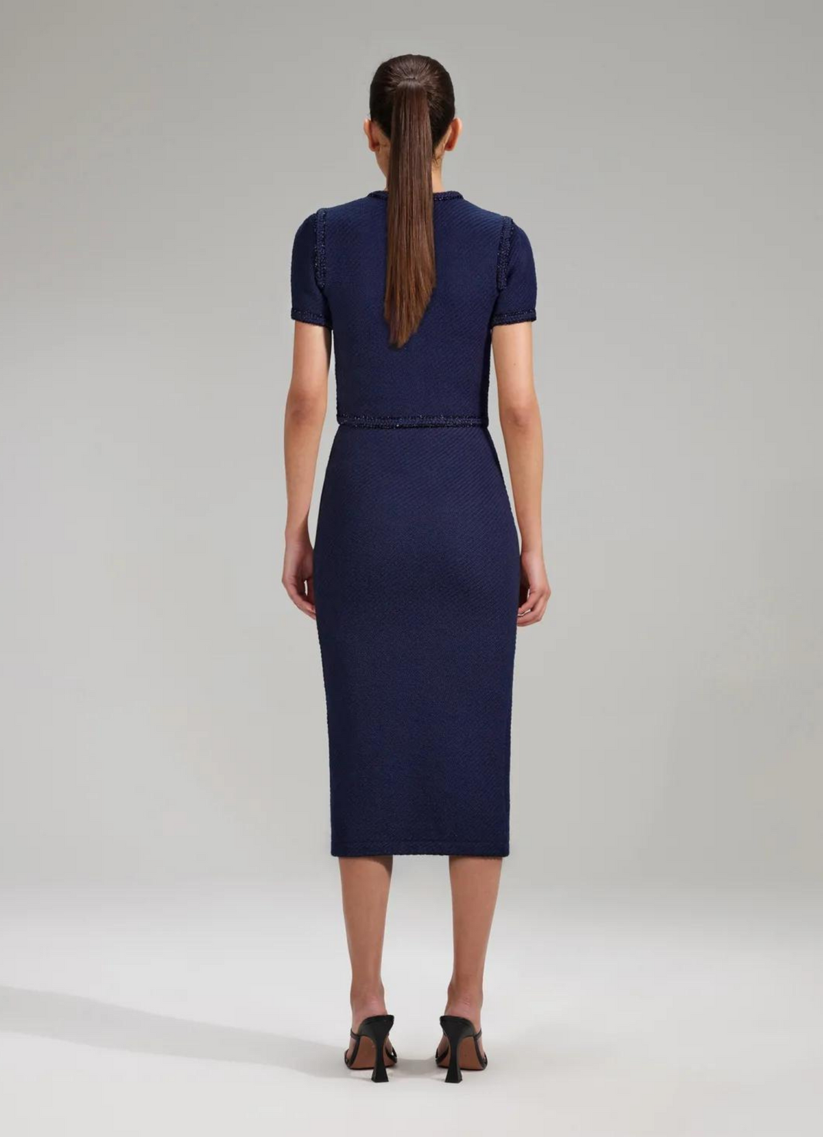 Midi navy knitted pull on skirt with two patch pockets and diamanté press stud buttons