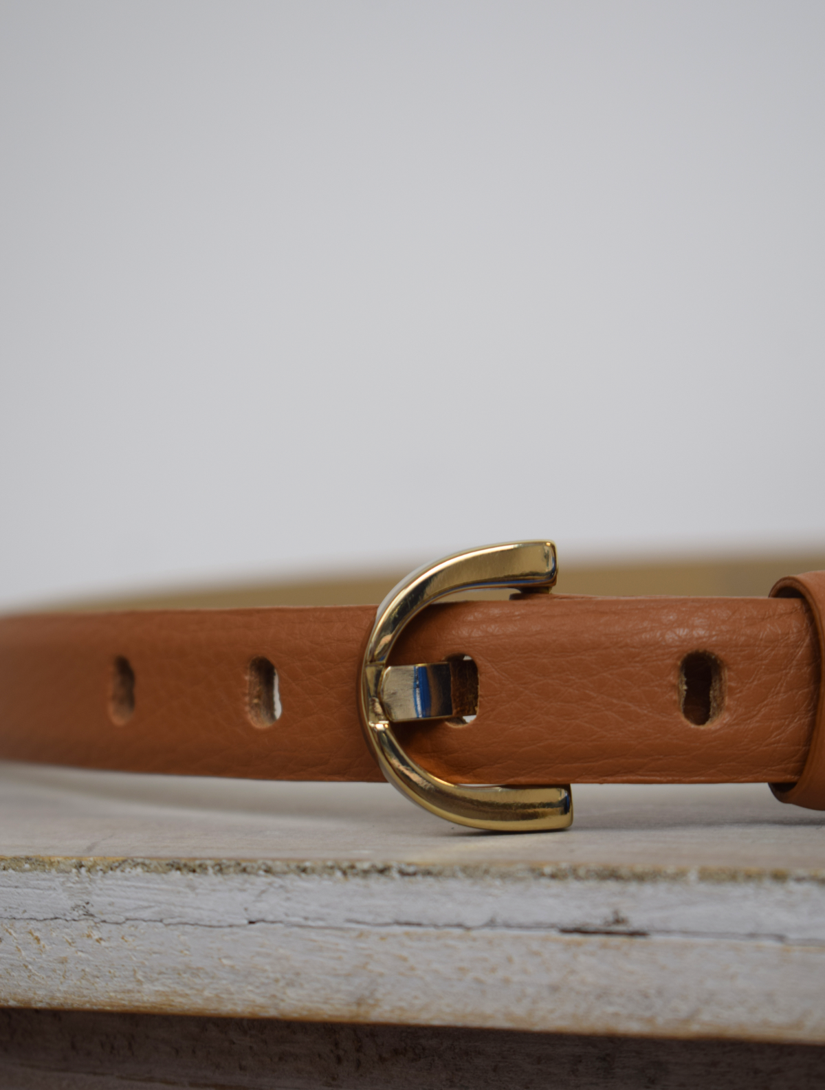 Thin tan belt with gold metallic D shaped buckle