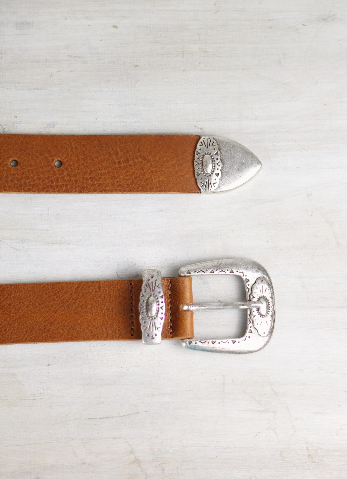 Western inspired leather belt from Spanish brand Mercules. The Fender Belt is cut from a soft brown leather and has a silver coloured buckle and pointer.  A perfect style and width for jeans, this belt can also be styled over dresses and knitwear too.