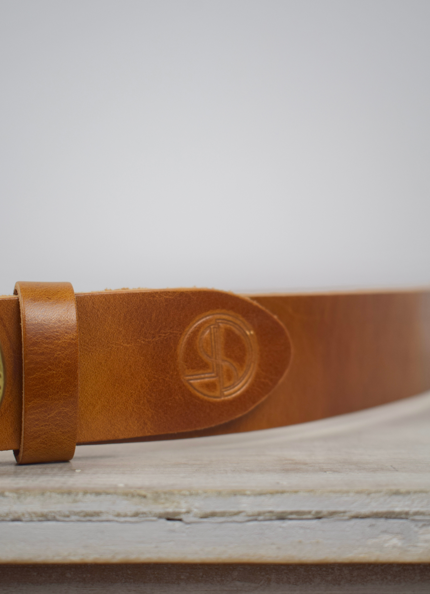 Tan leather bag strap with bronze salamander with lizard buckle