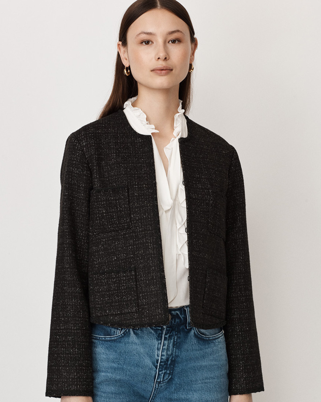Black boxy smart cropped jacket with four patch pockets and hook and eye fastening to the neck with long sleeves and edge lace trim details.