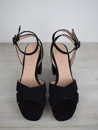 Suede black platform sandal with cross straps and ankle strap with buckle fastening