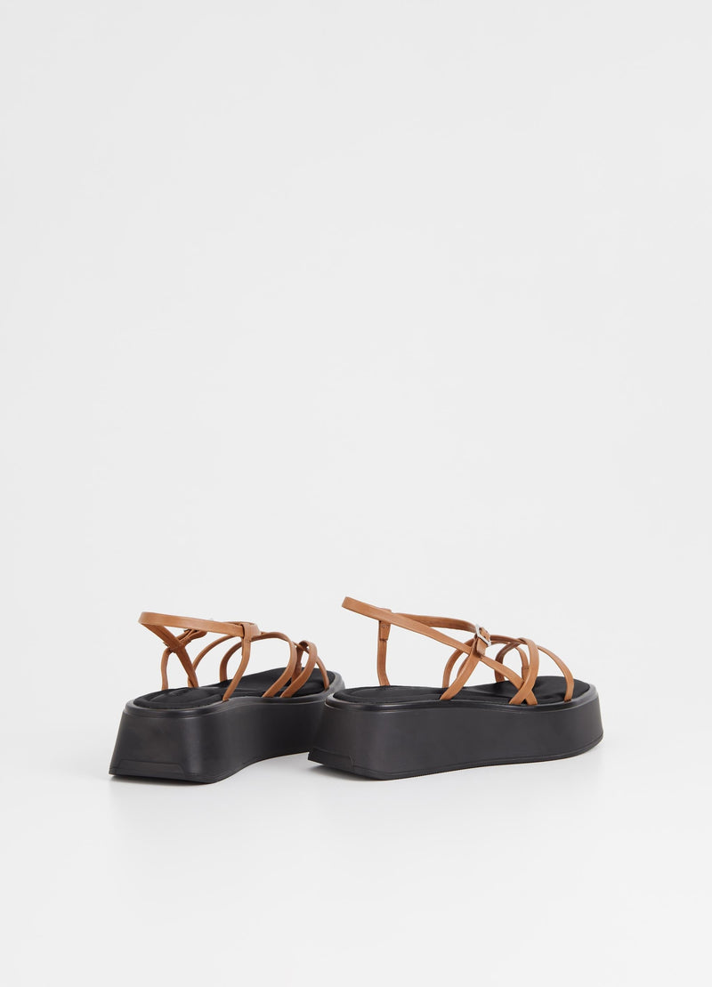 Strappy tan sandal with chunky black rubber sole