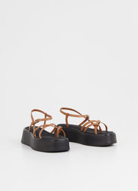Strappy tan sandal with chunky black rubber sole
