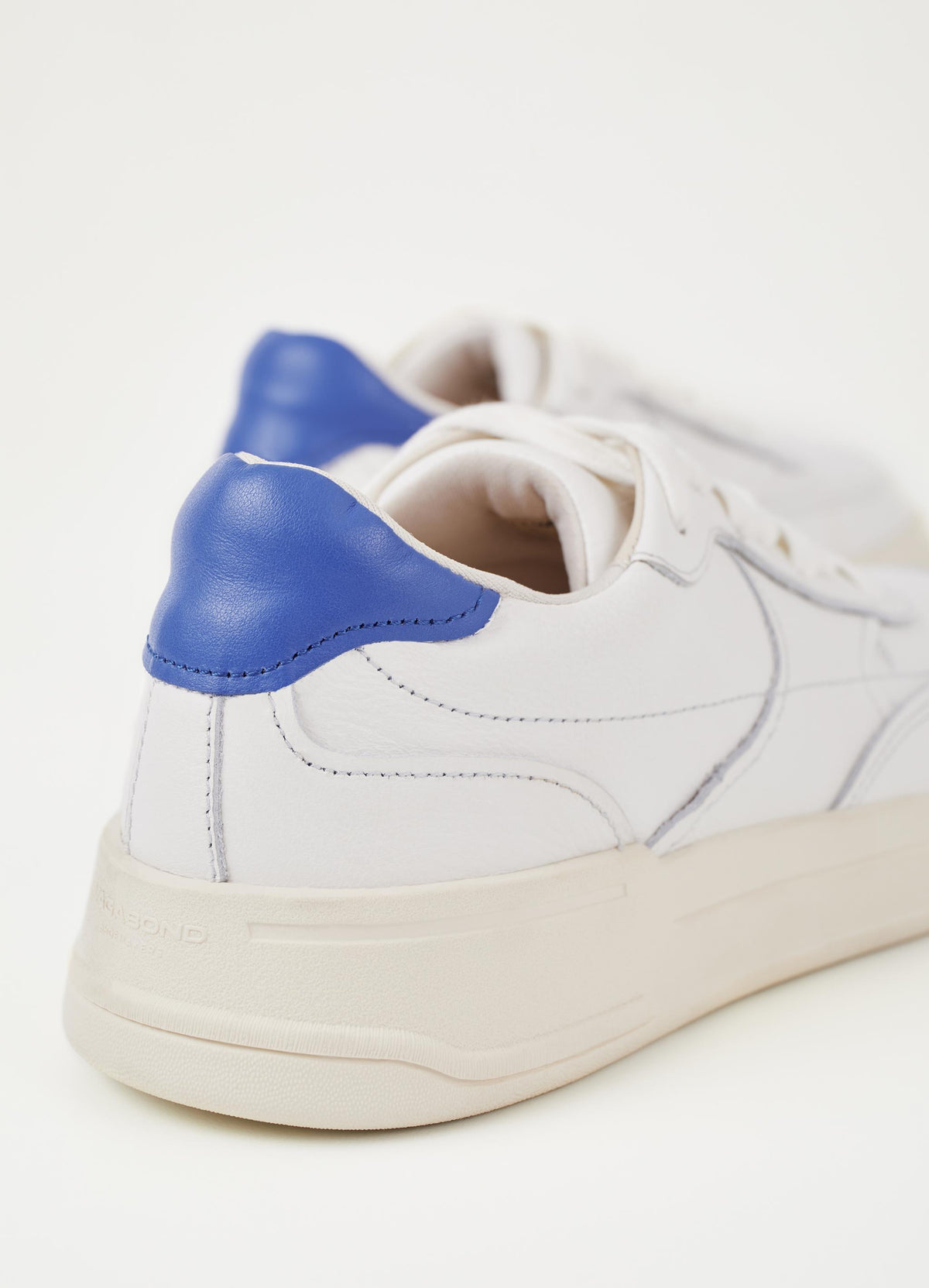 White trainer with cobalt blue heel and white laces